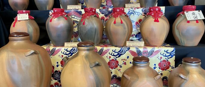 Awamori aging pots on stepped shelves at Chuko Shuzo in Okinawa.